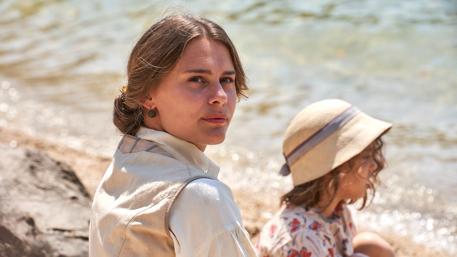 young woman sitting on beach 