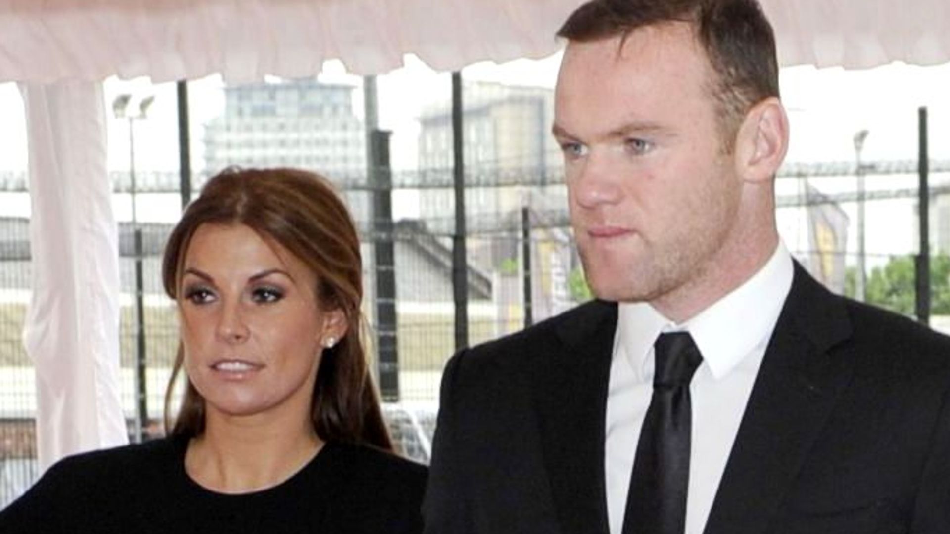 Wayne Rooney and Coleen Rooney in matching black outfits