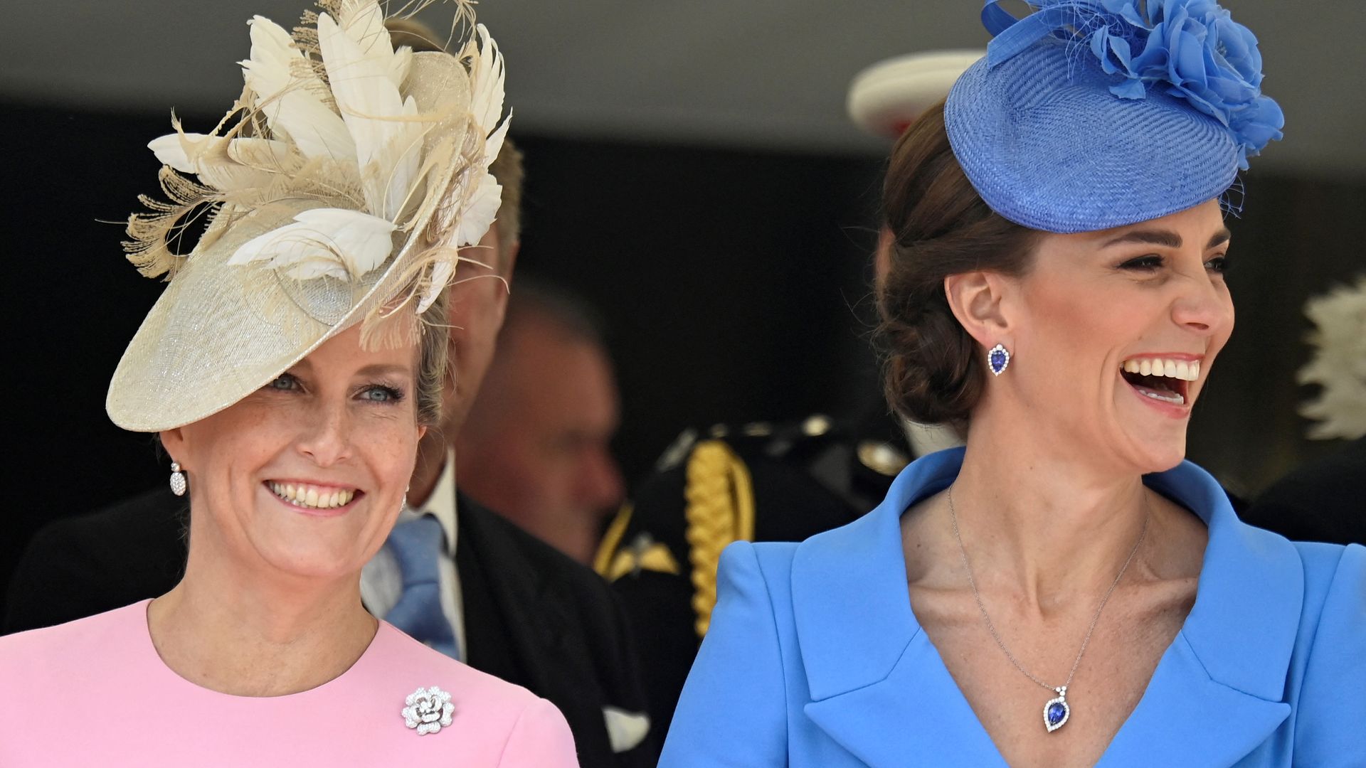 The Duchess of Edinburgh in pink and the Princess of Wales smiling in blue