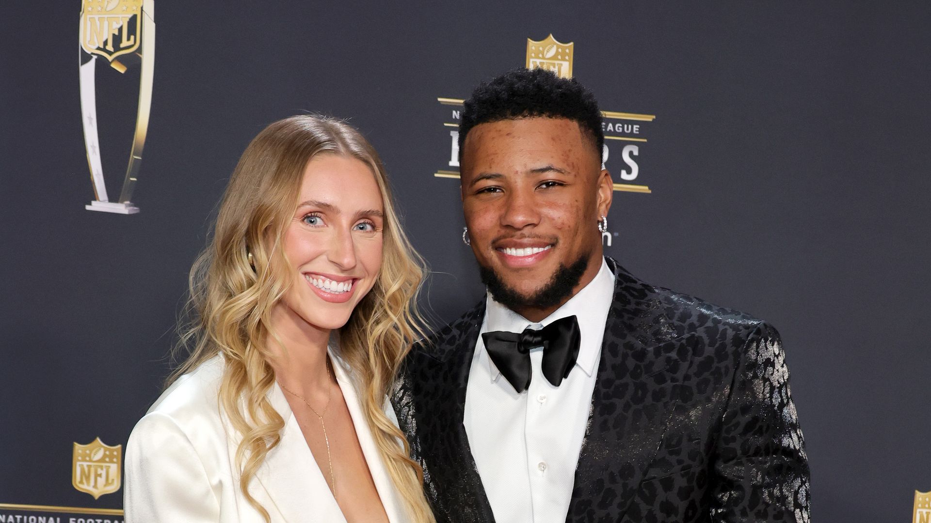 saquon barkley and anna congdon on red carpet in suits