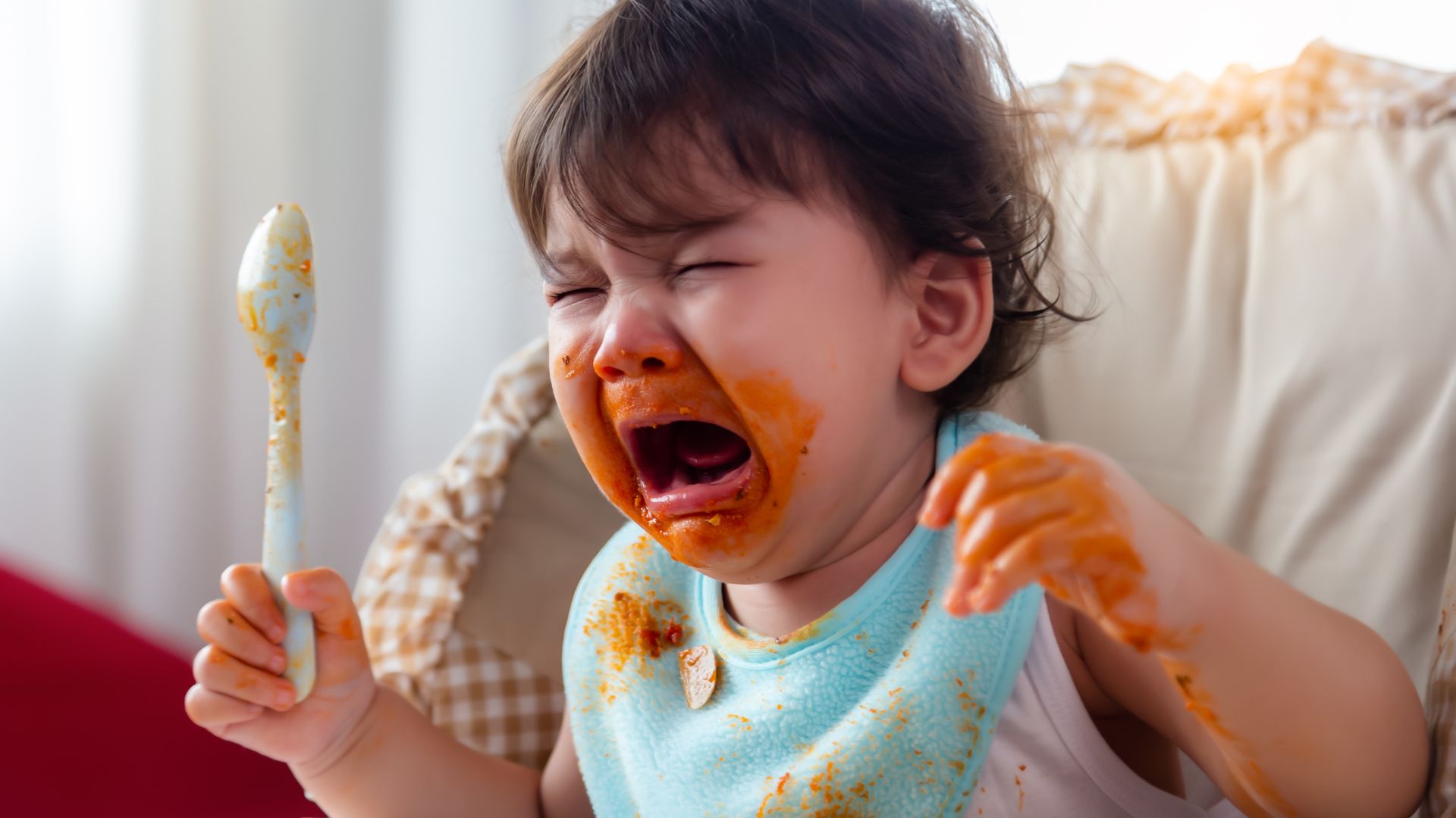 Baby toddler having tantrum while eating