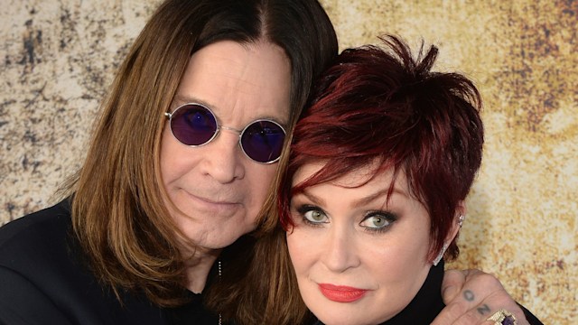 Ozzy Osbourne and Sharon Osbourne embracing looking serious in black