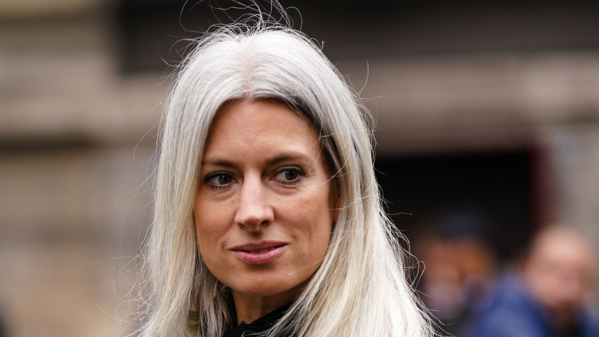 Sarah Harris wears a mustard-yellow oversized coat, a black turtleneck, outside Akris, during Paris Fashion Week - Womenswear Fall/Winter 2020/2021, on March 02, 2020 in Paris, France. 