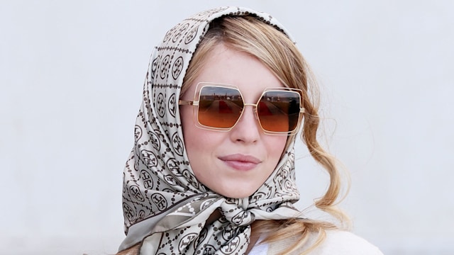 Sydney Sweeney wearing a headscarf and sunglasses 