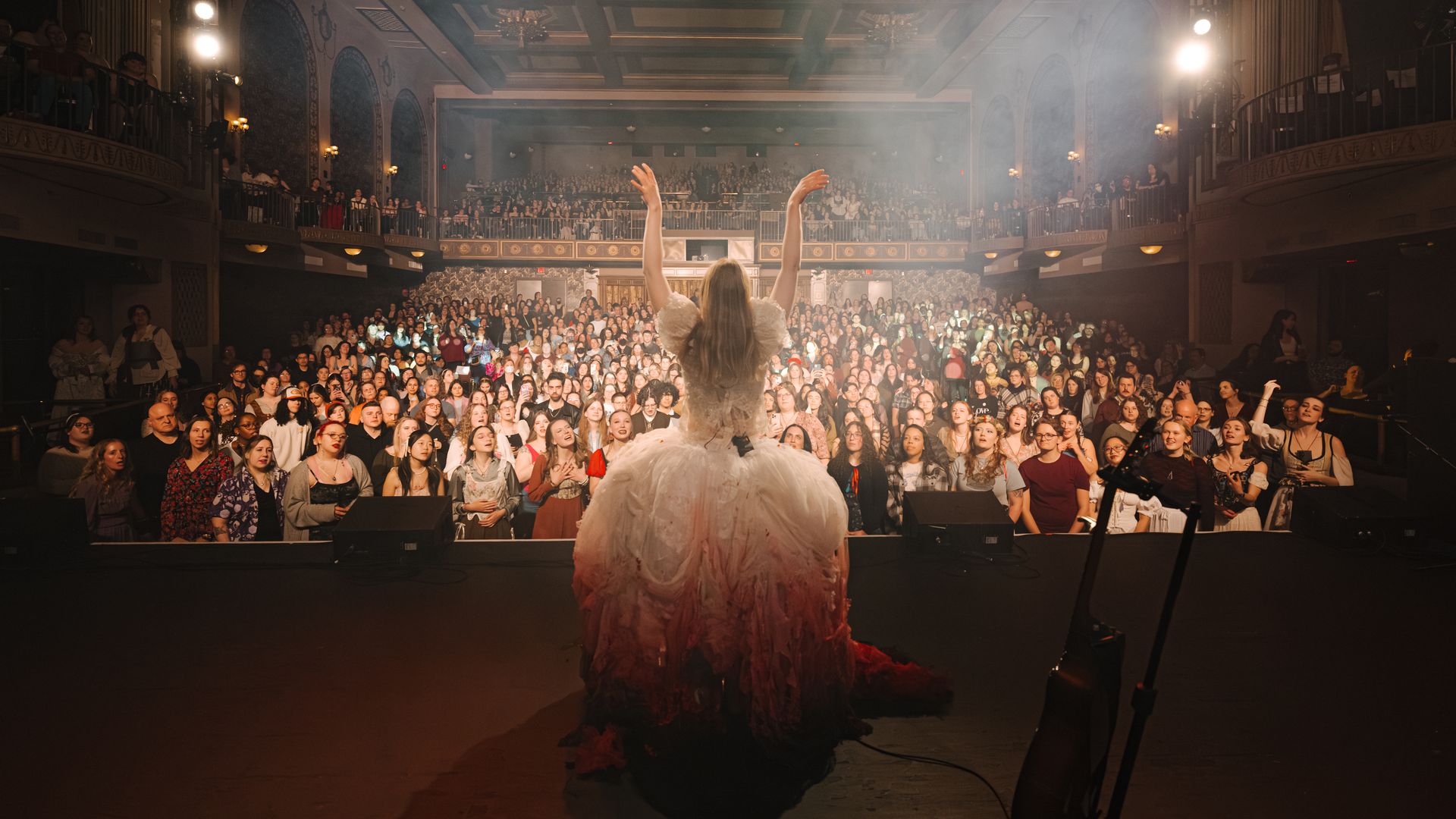 Paris Paloma performs onstage in a giant gown