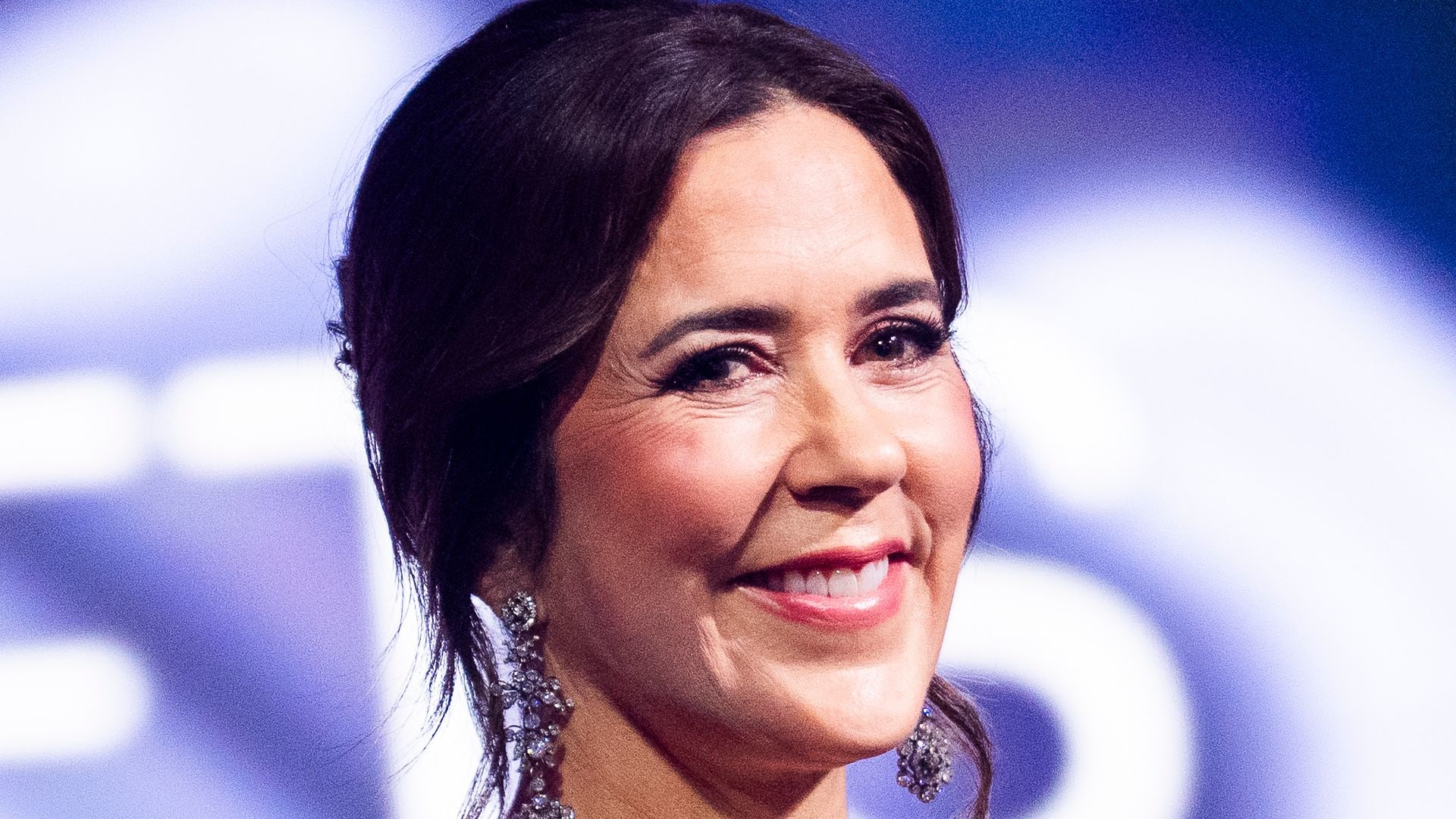 Queen Mary smiling in black dress with hair up