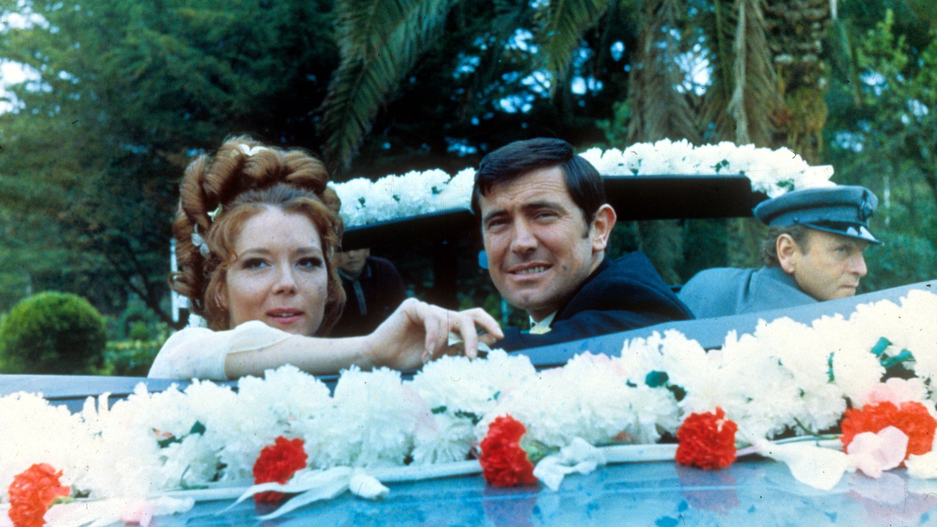 Diana Rigg and George Lazenby in a wedding car in On Her Majesty's Secret Service