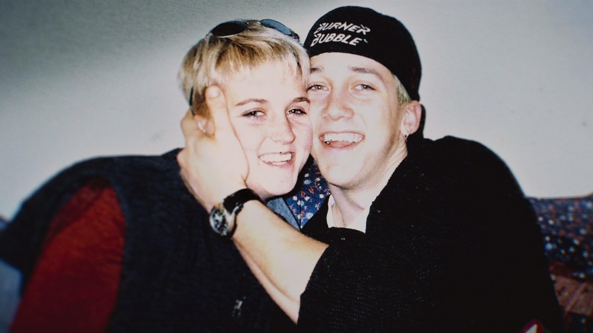 woman and man hugging and smiling