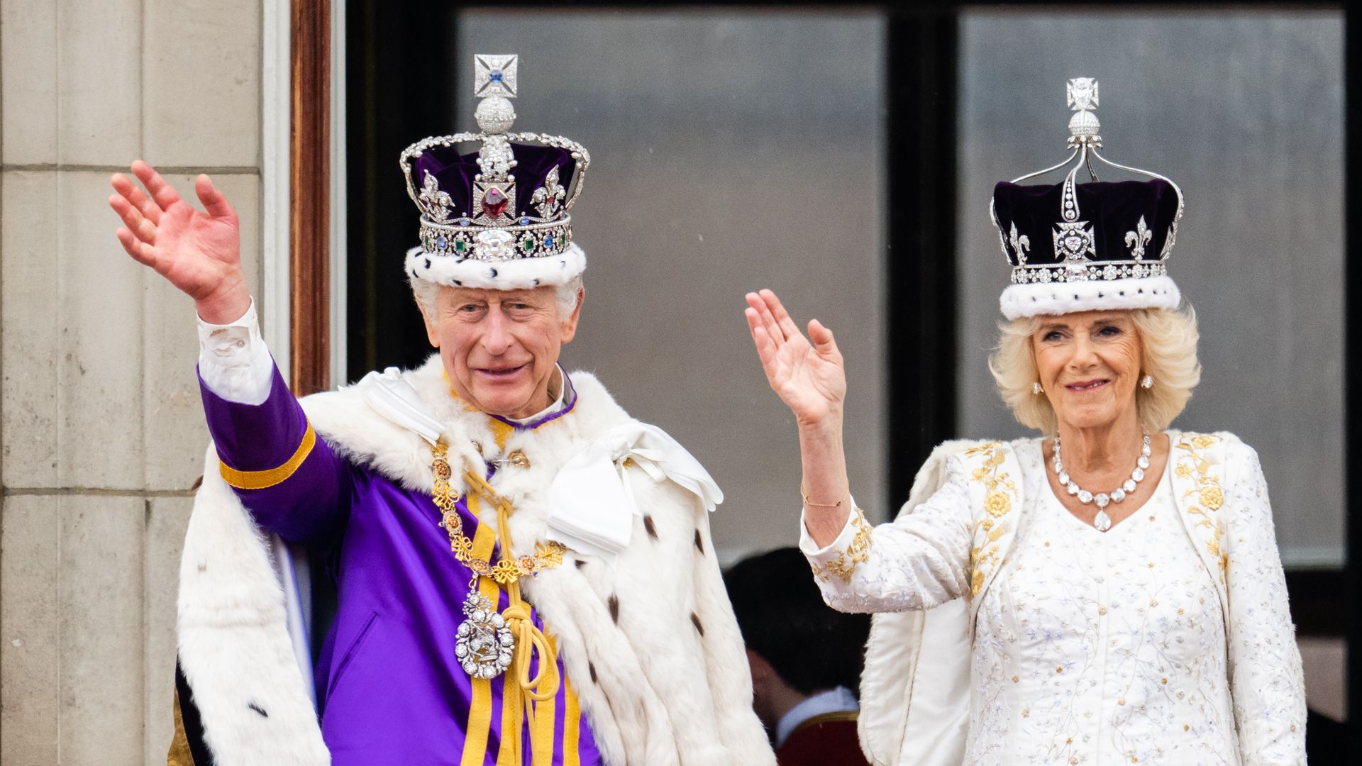 King Charles and Queen Camilla waving from palace balcony on coronation day