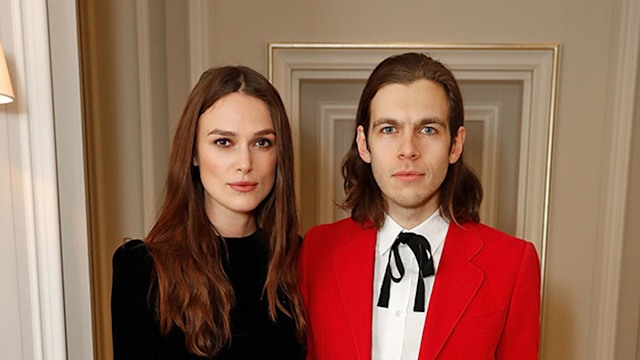 Keira Knightley in a blackd ress and James Righton in a red suit