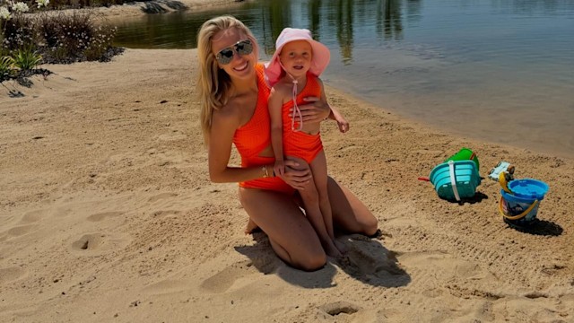 brittany mahomes and her daughter stirling on the beach in neon green swimsuits