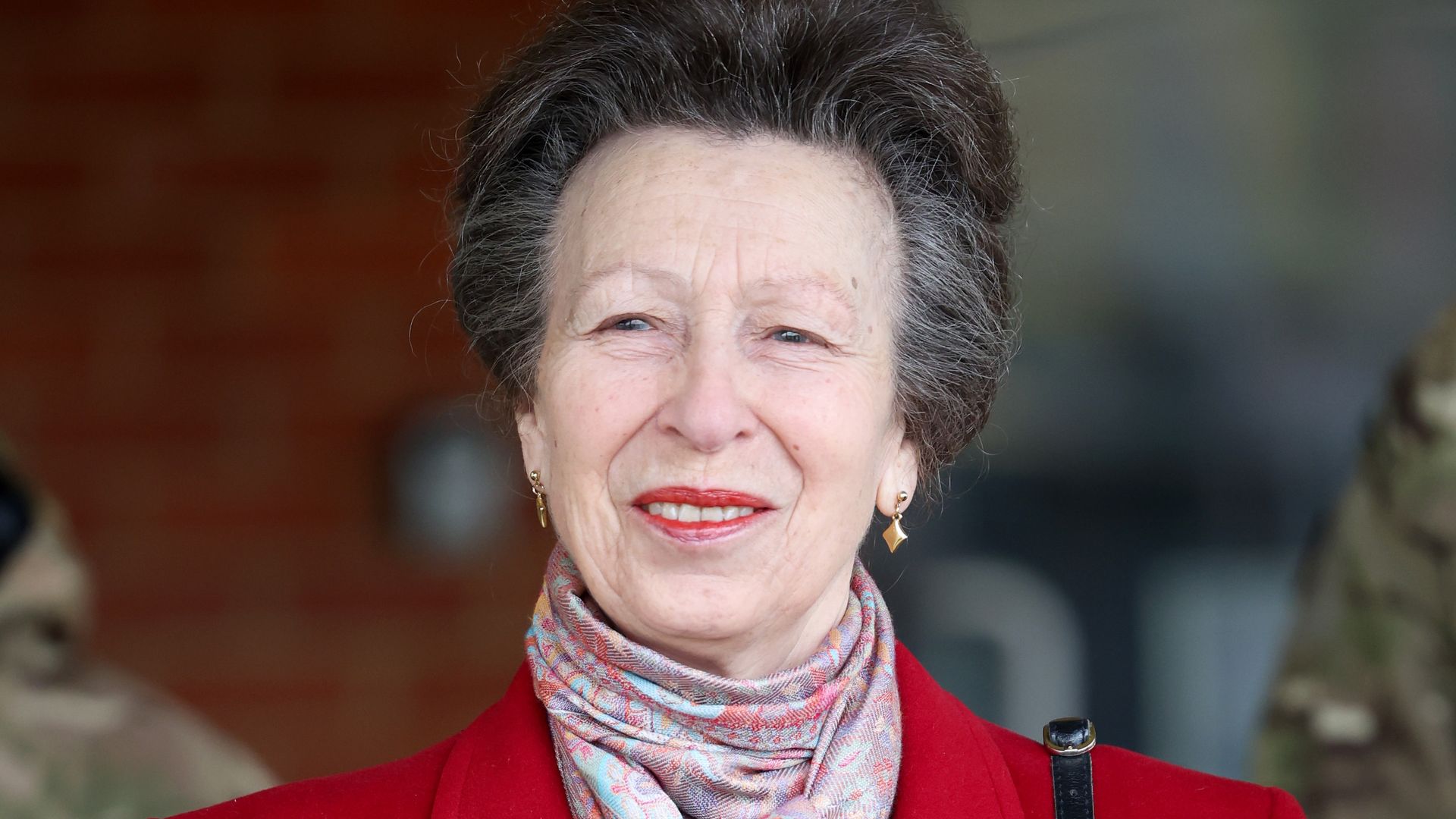 Princess Anne in red coat and patterned scarf