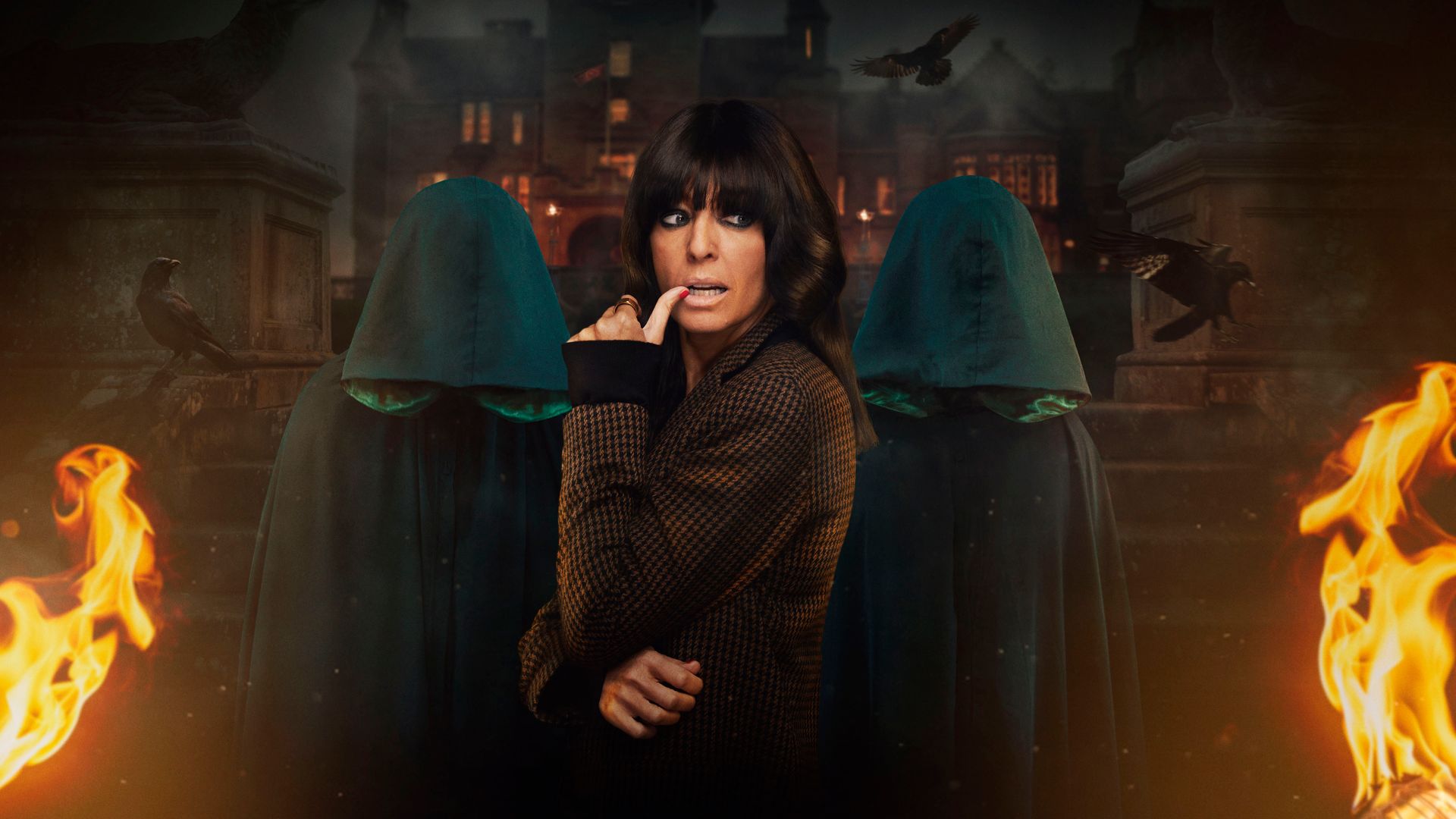 Claudia Winkleman in tweed jacket with two figures in green robes and hoods