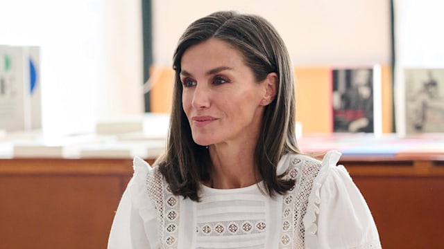 Queen Letizia at desk in white blouse