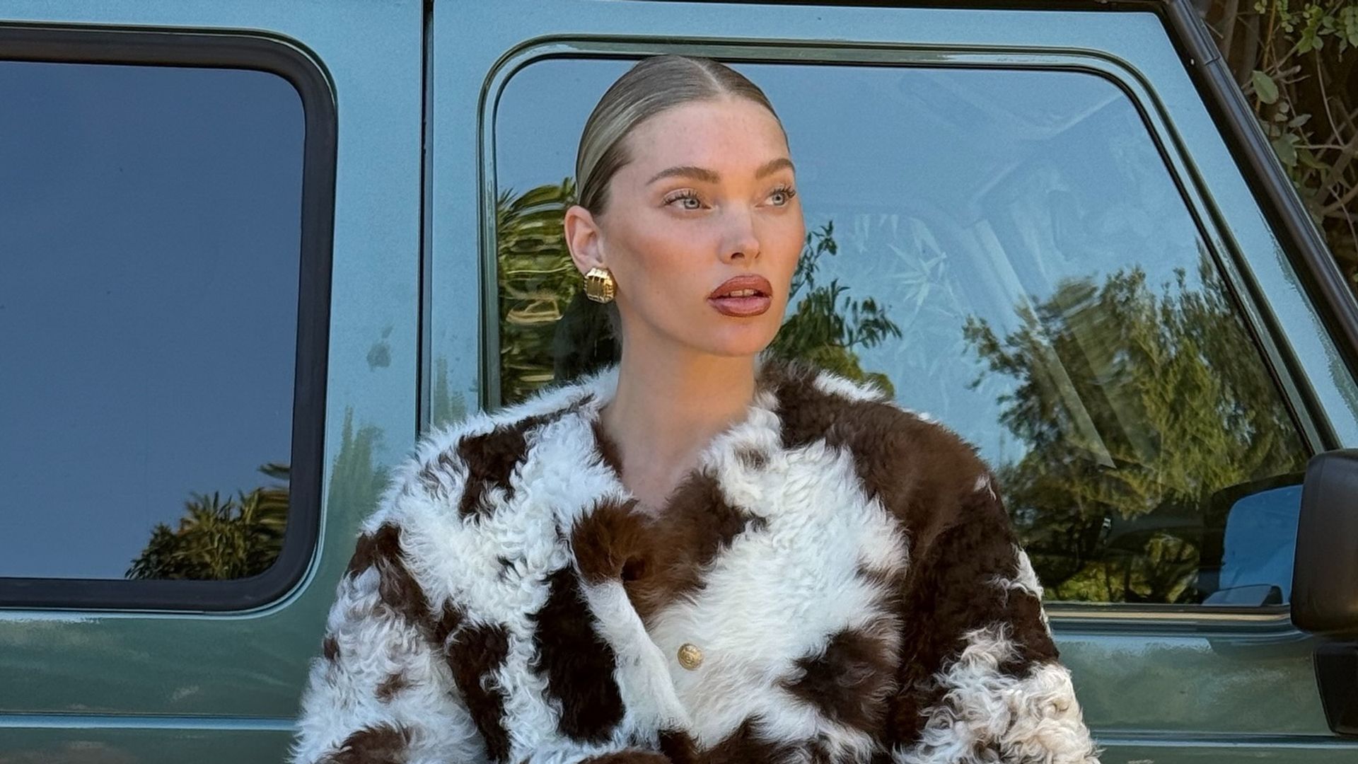 Elsa Hosk poses in a fluffy cow-print jacket and jeans on her Instagram