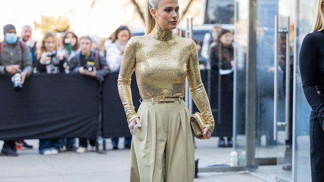 NAmelia Spencer wears golden top, beige pants outside Michael Kor New York Fashion WeekEW YORK, NEW YORK - FEBRUARY 15: Amelia Spencer wears golden top, beige pants outside Michael Kor New York Fashion Week during on February 15, 2023 in New York City. (P
