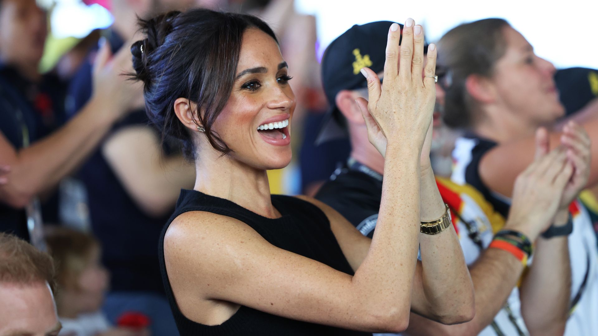 Meghan Markle applauding in black outfit