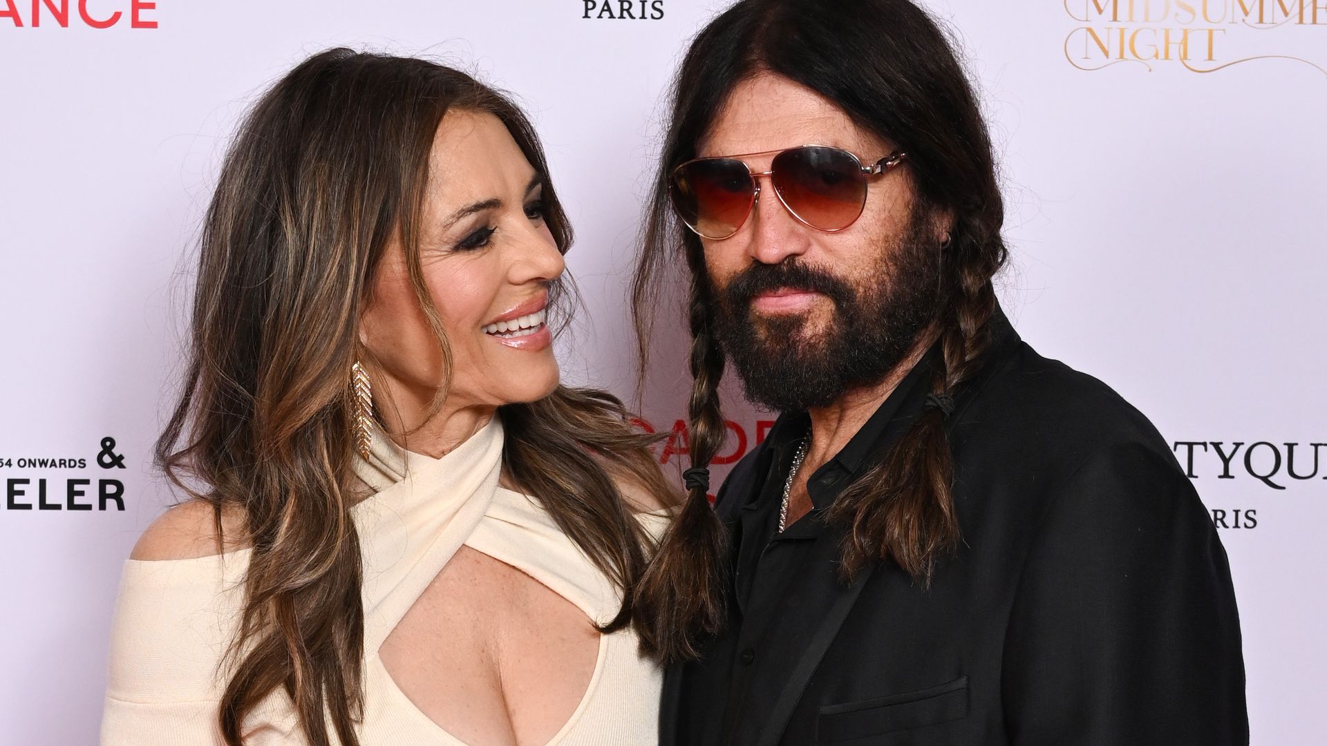 Elizabeth Hurley dazzles in plunging gown as she cozies up with Billy Ray Cyrus