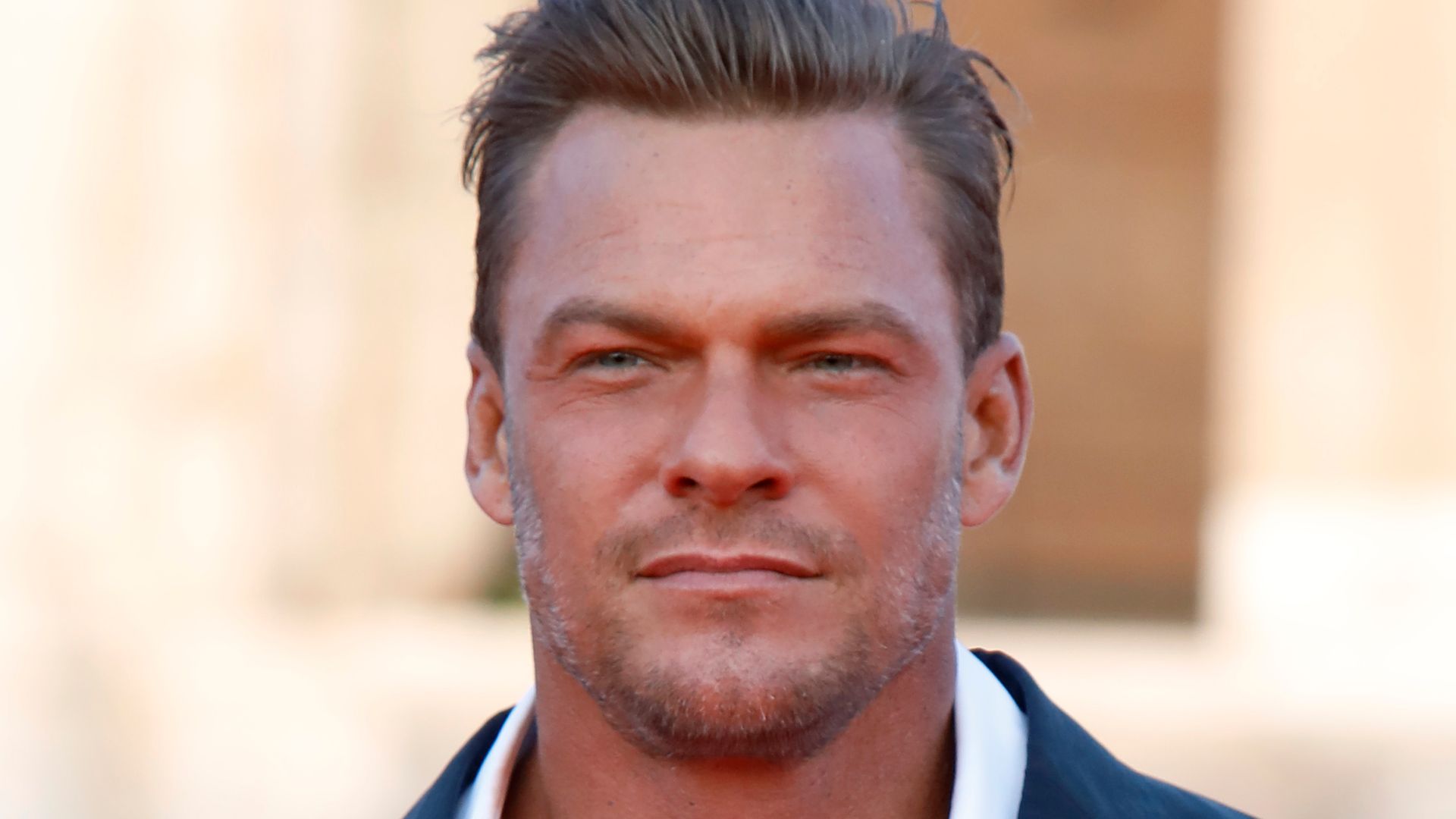 Alan Ritchson suit, white shirt tanned
