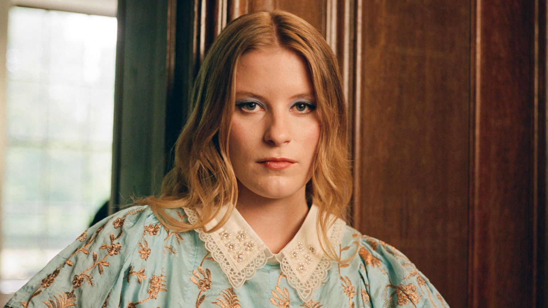 Paris Paloma poses in a blue collared Bora Aksu dress 