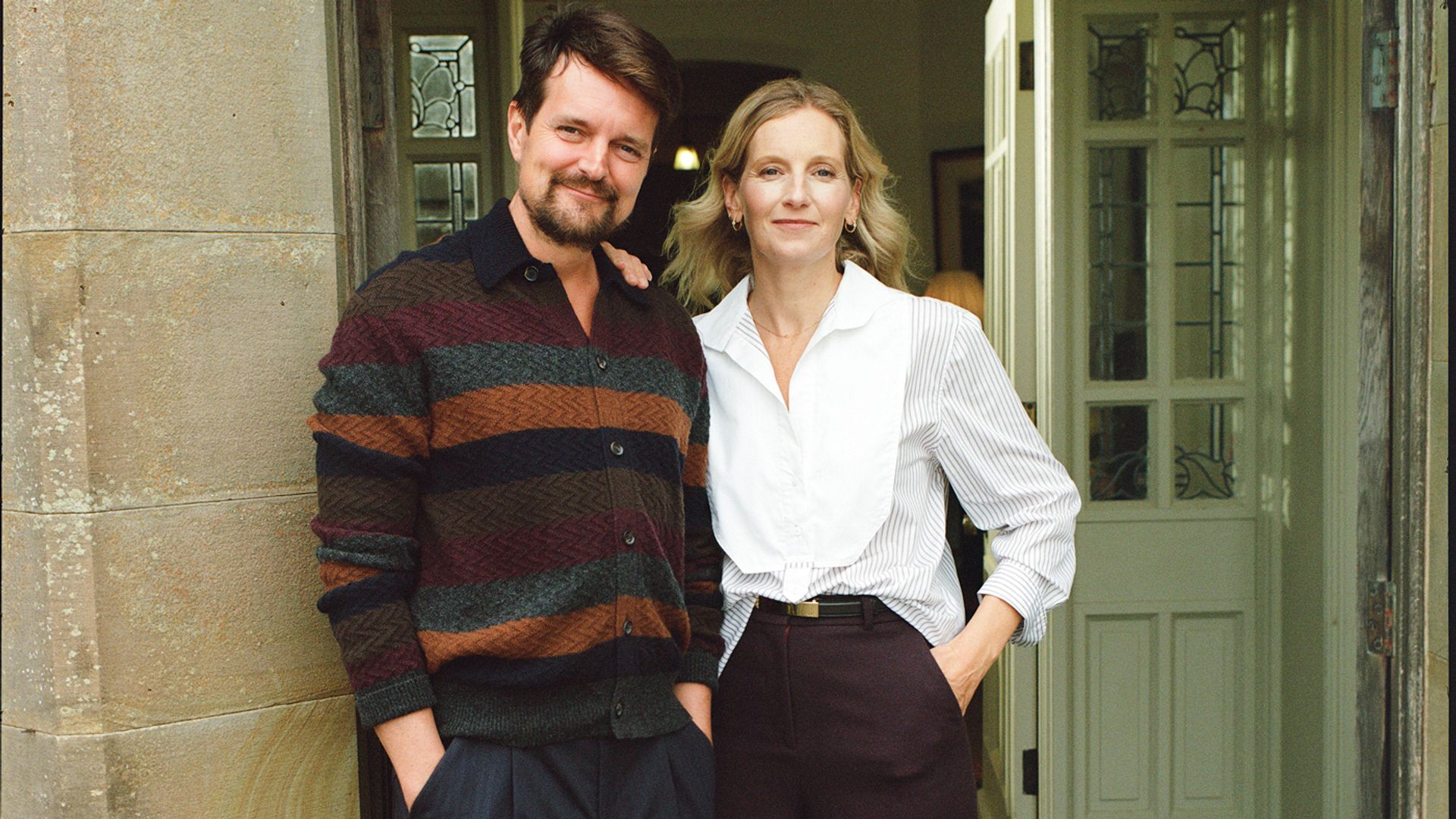 Savannah Miller and her husband, James Whewell, standing at the door of their home 
