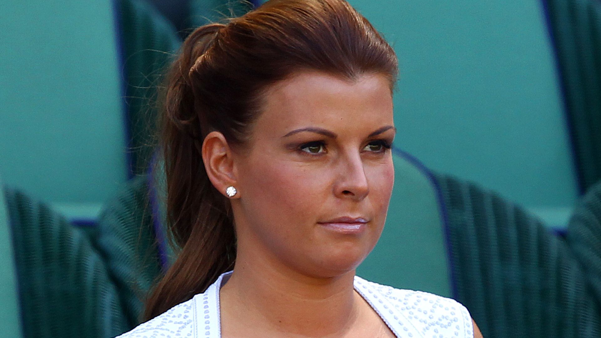 Coleen Rooney in a white dress with her hair in a ponytail attends the Gentlemen's Singles Final match in 2013