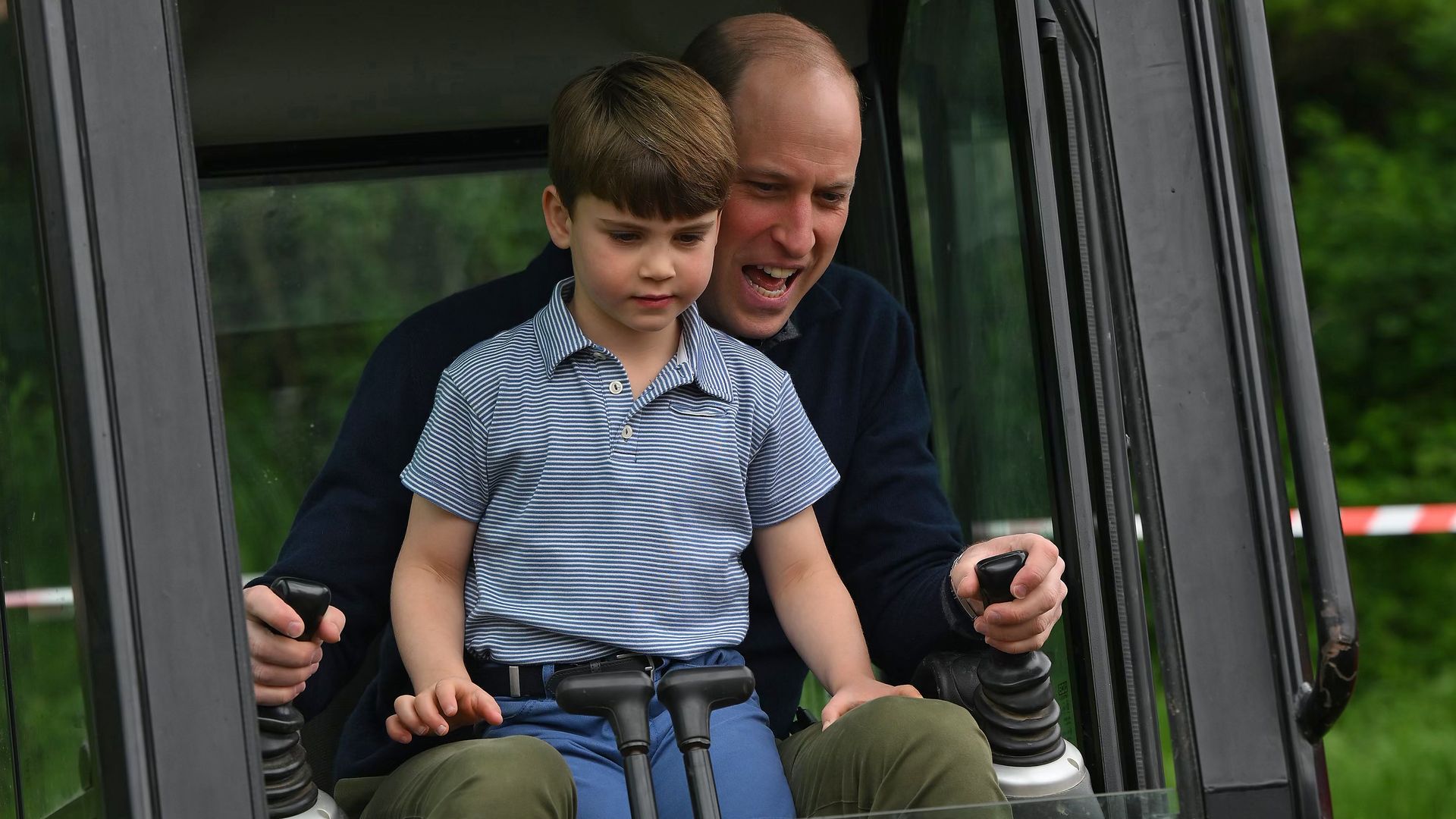 Prince William and Prince louis excavating in a digger