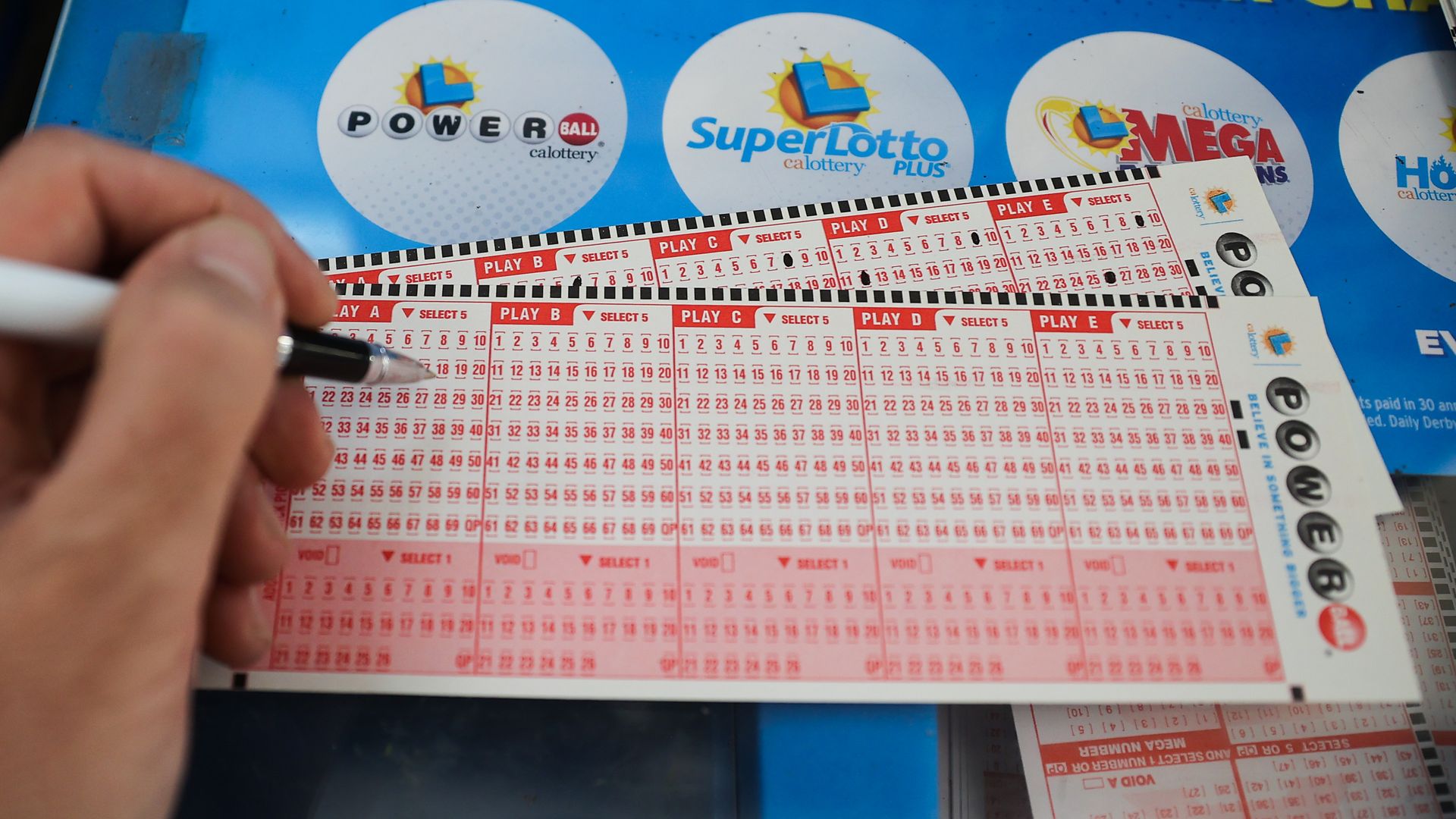 A lottery ticket being filled in on a desk