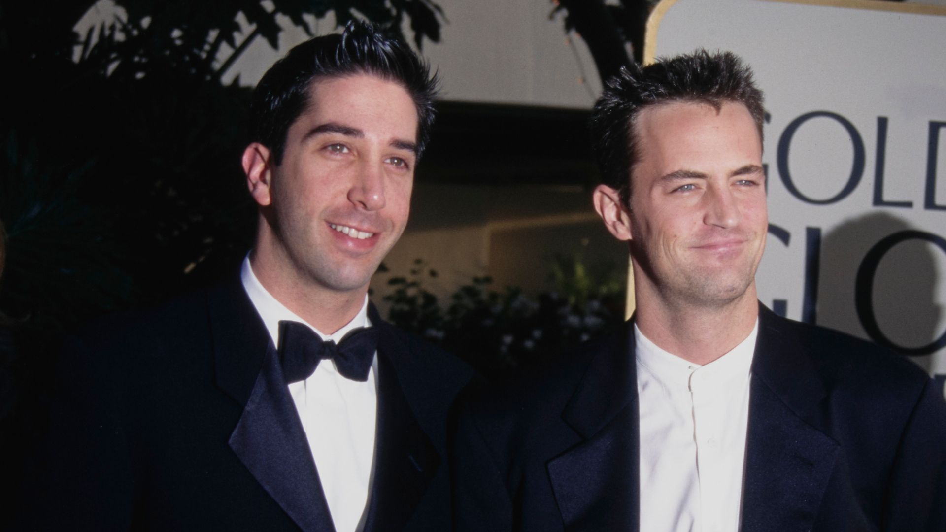 American actor David Schwimmer and Canadian-American actor Matthew Perry attend the 54th Golden Globe Awards, held at the Beverly Hilton Hotel in Beverly Hills, California, 19th January 1997. The man to the right of the frame is