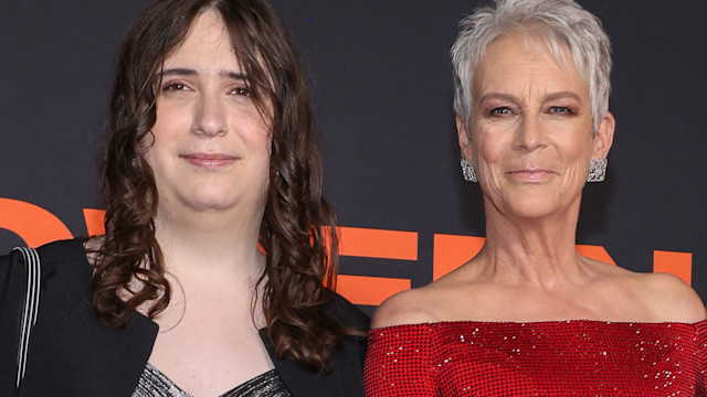 Jamie Lee Curtis in a red off the shoulder dress with her daughters