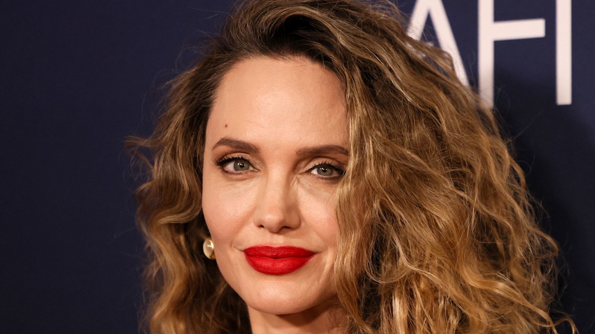 Angelina Jolie rocks figure-hugging liquid gold dress and tumbling curls