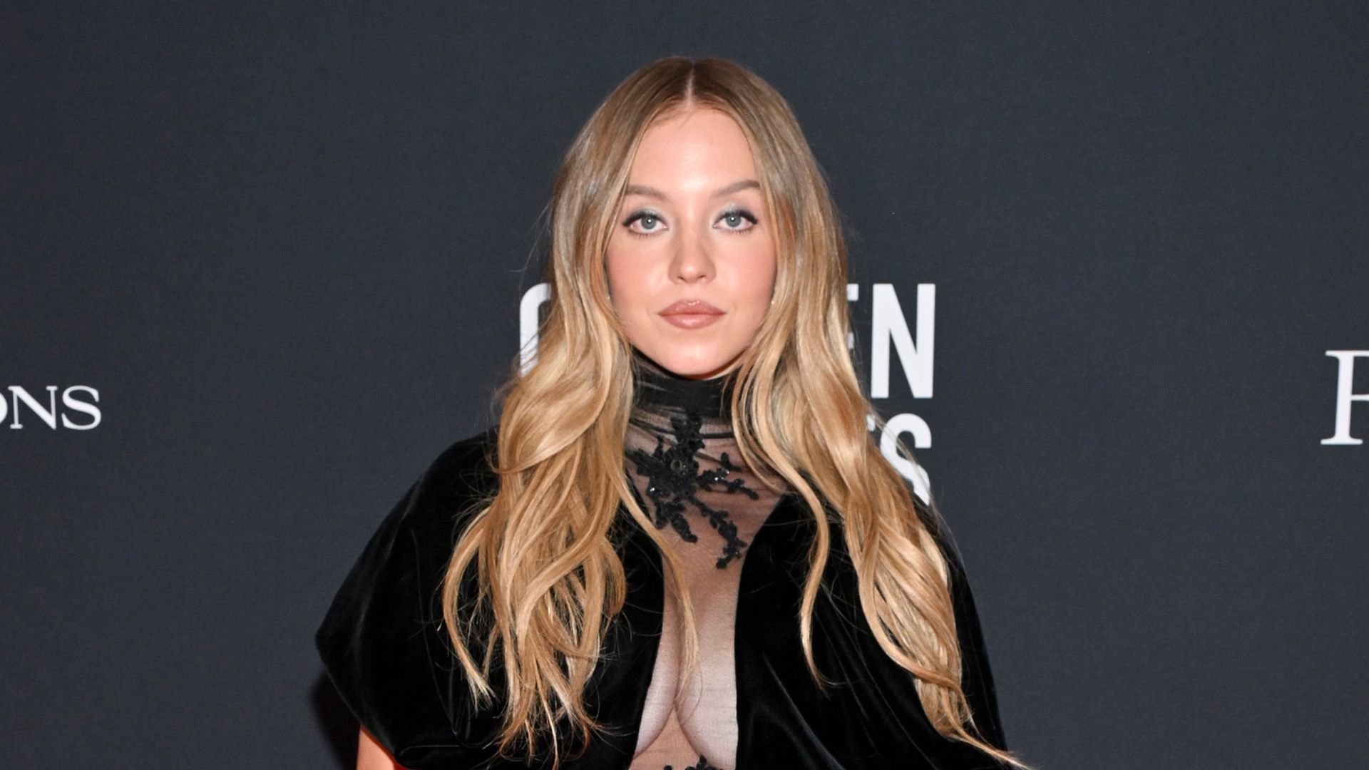 photo of sydney sweeney in black dress with sheer chest panel