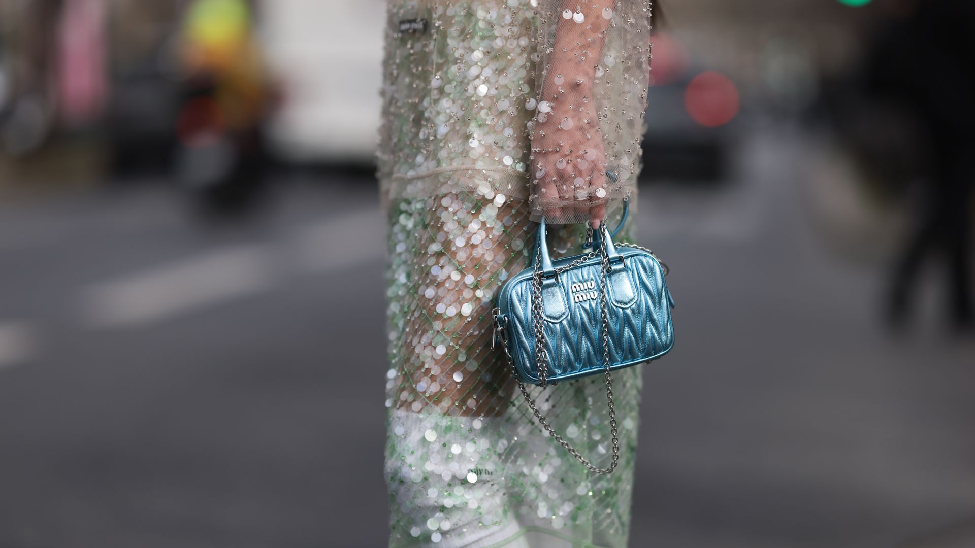  Fer Millan Delaroiere seen wearing a transparent glitter sequins dress with a blue shiny bag, white socks and white plateau heels 
