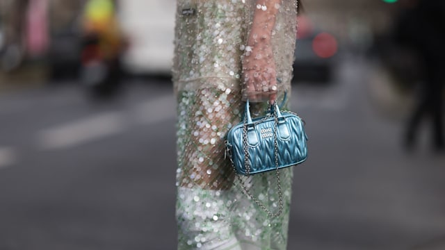  Fer Millan Delaroiere seen wearing a transparent glitter sequins dress with a blue shiny bag, white socks and white plateau heels 