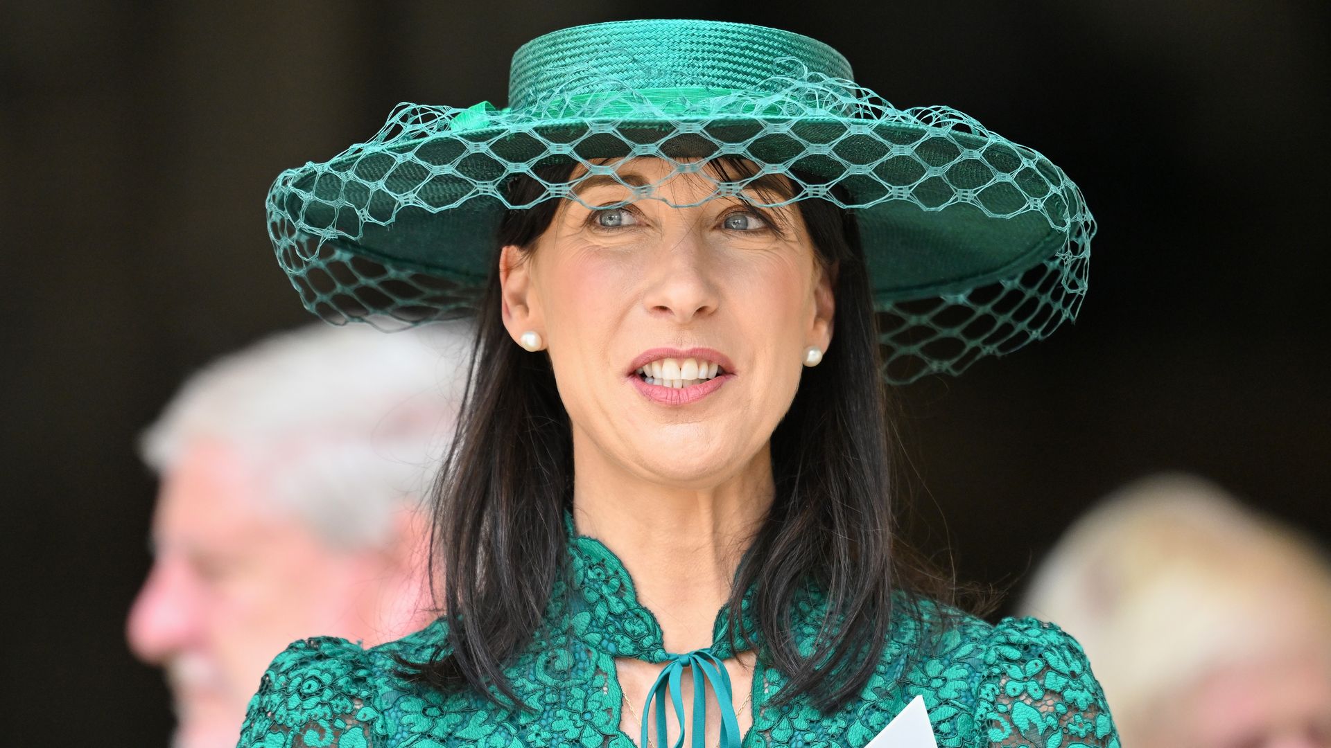 A close-up photo of Samantha Cameron wearing a green hat and green dress 