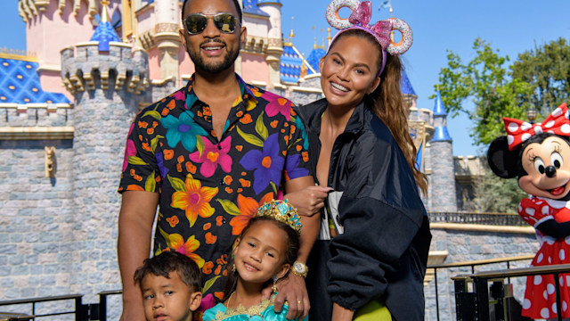 John Legend, Chrissy Teigen and their children, Miles and Luna pose with Minnie Mouse