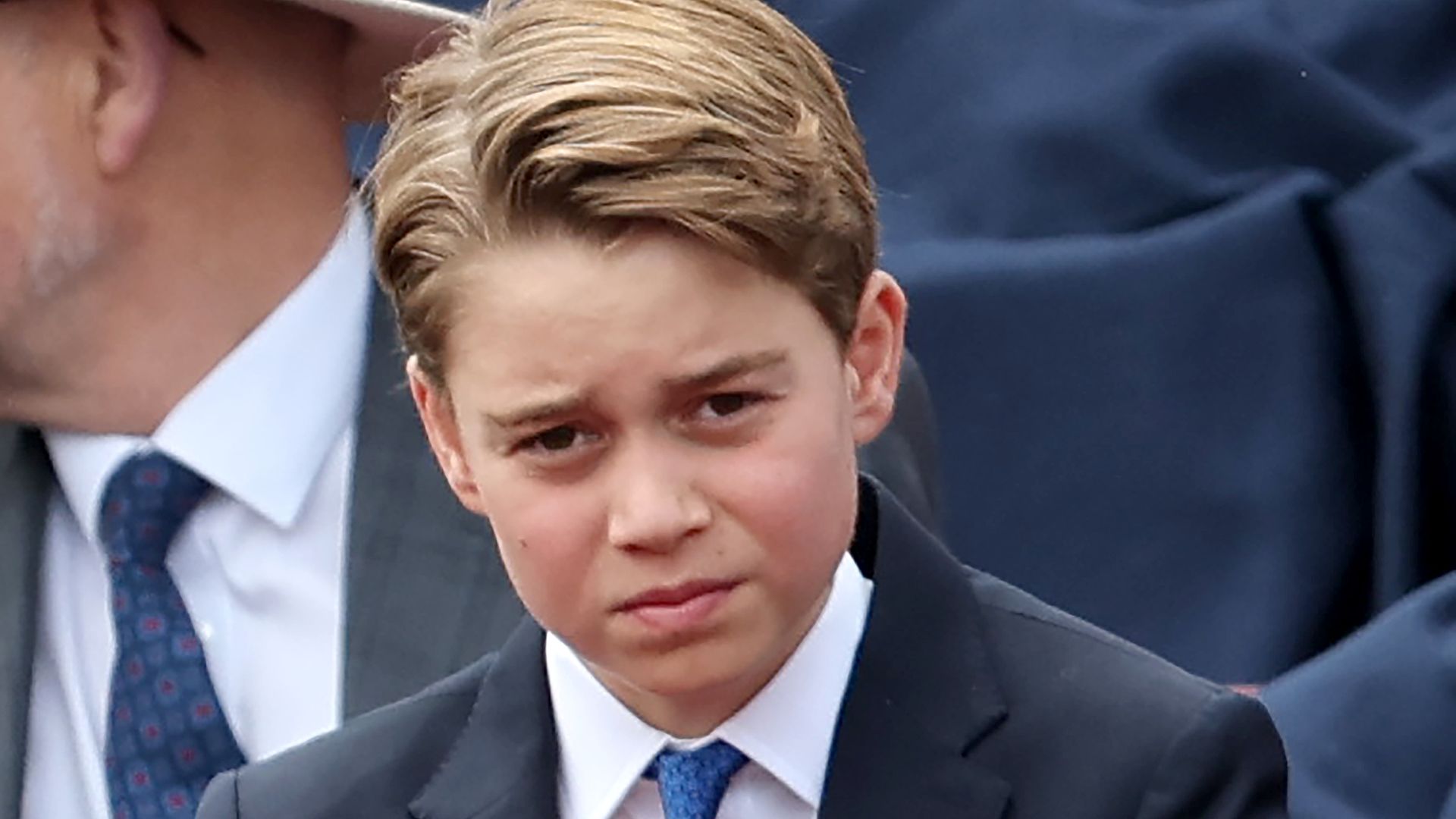 Prince George adjusting tie
