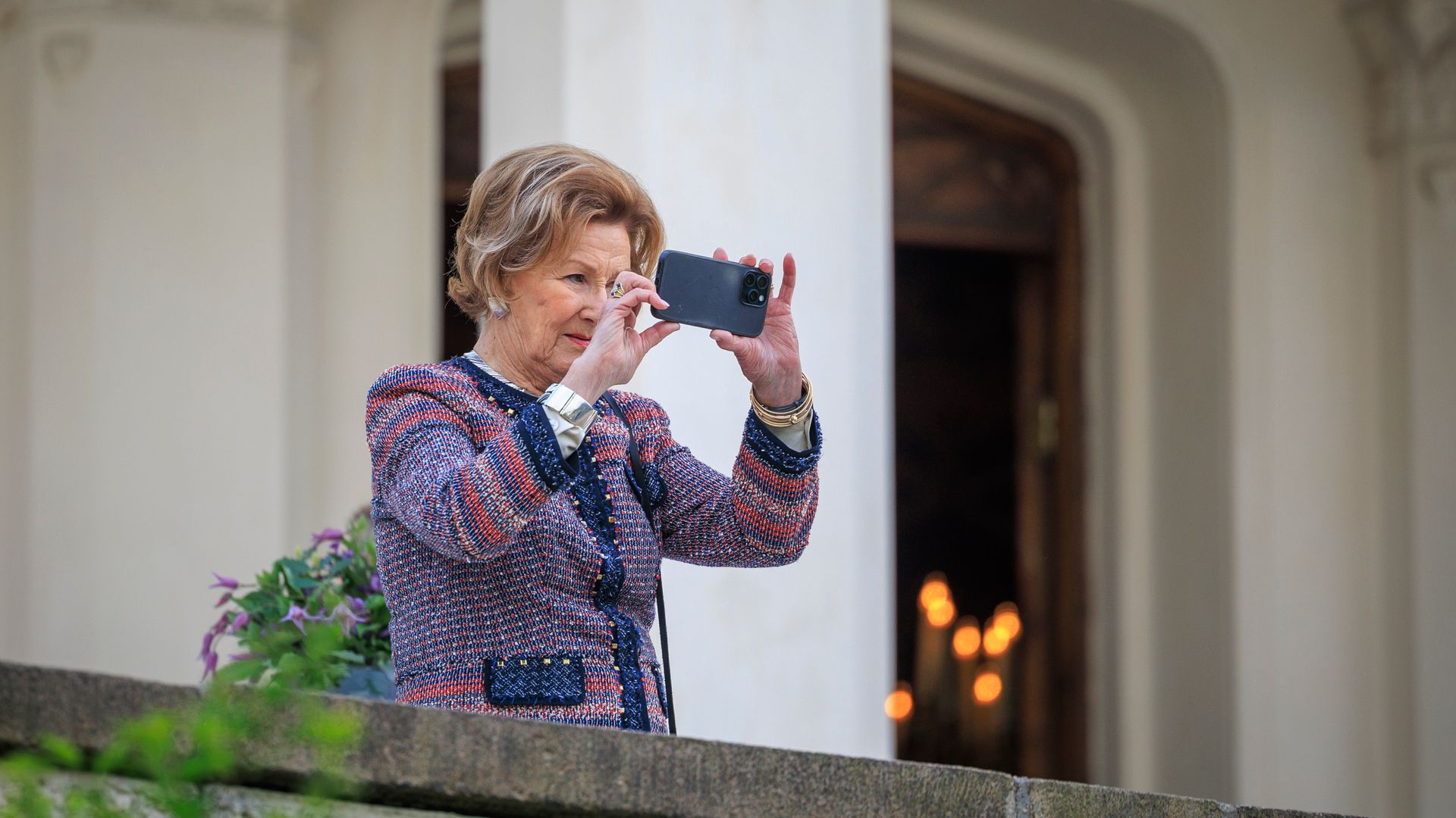 Queen Sonja taking photos on her mobile phone