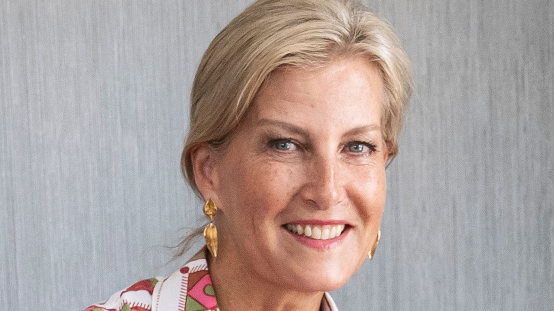 Sophie, Duchess of Edinburgh smiling in pink printed dress