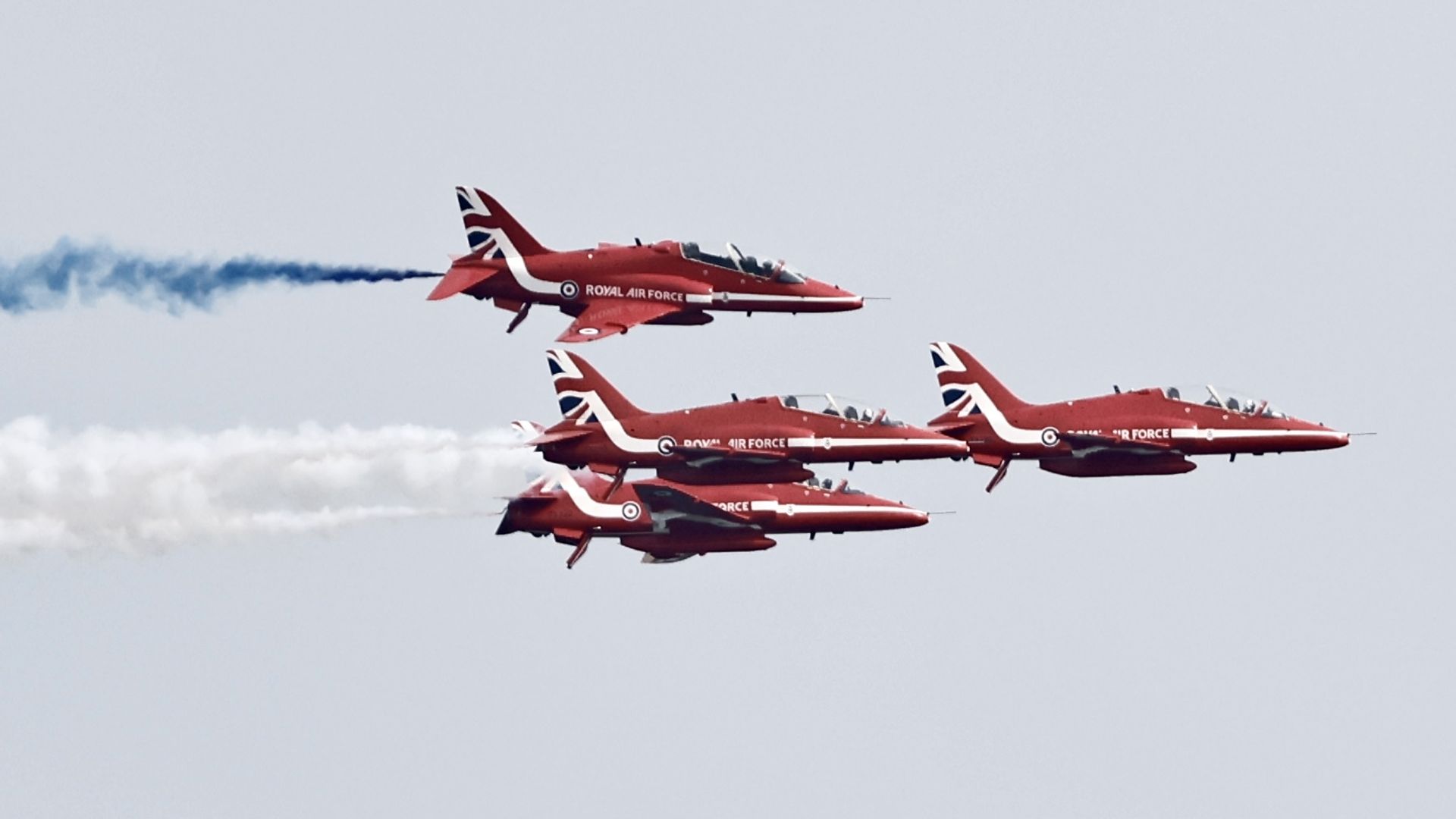 Four Red Arrows aircraft in flight