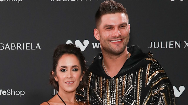 Janette Manrara in a blue dress and Aljaz Skorjanec in black trousers and a bejewelled shirt