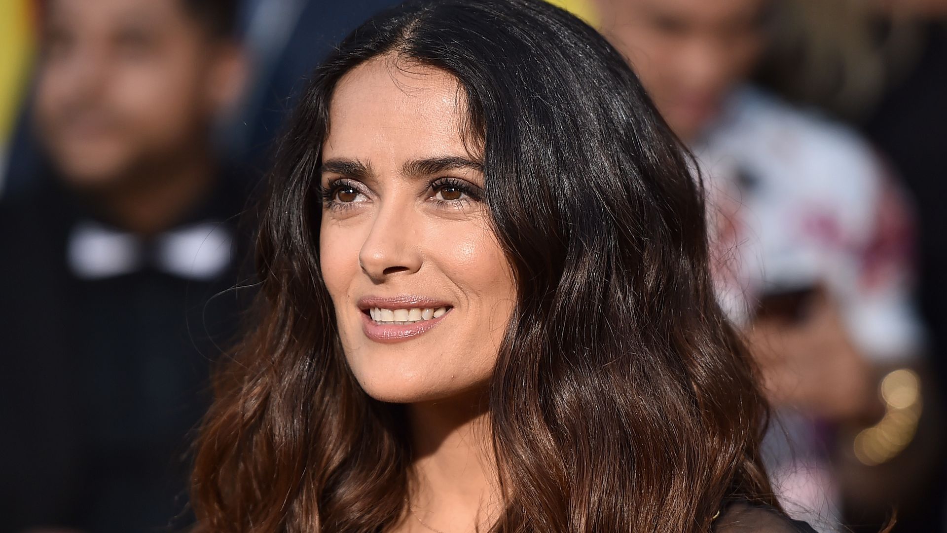 Salma Hayek with wavy hair and neutral makeup at Sony's Sausage Party in 2016