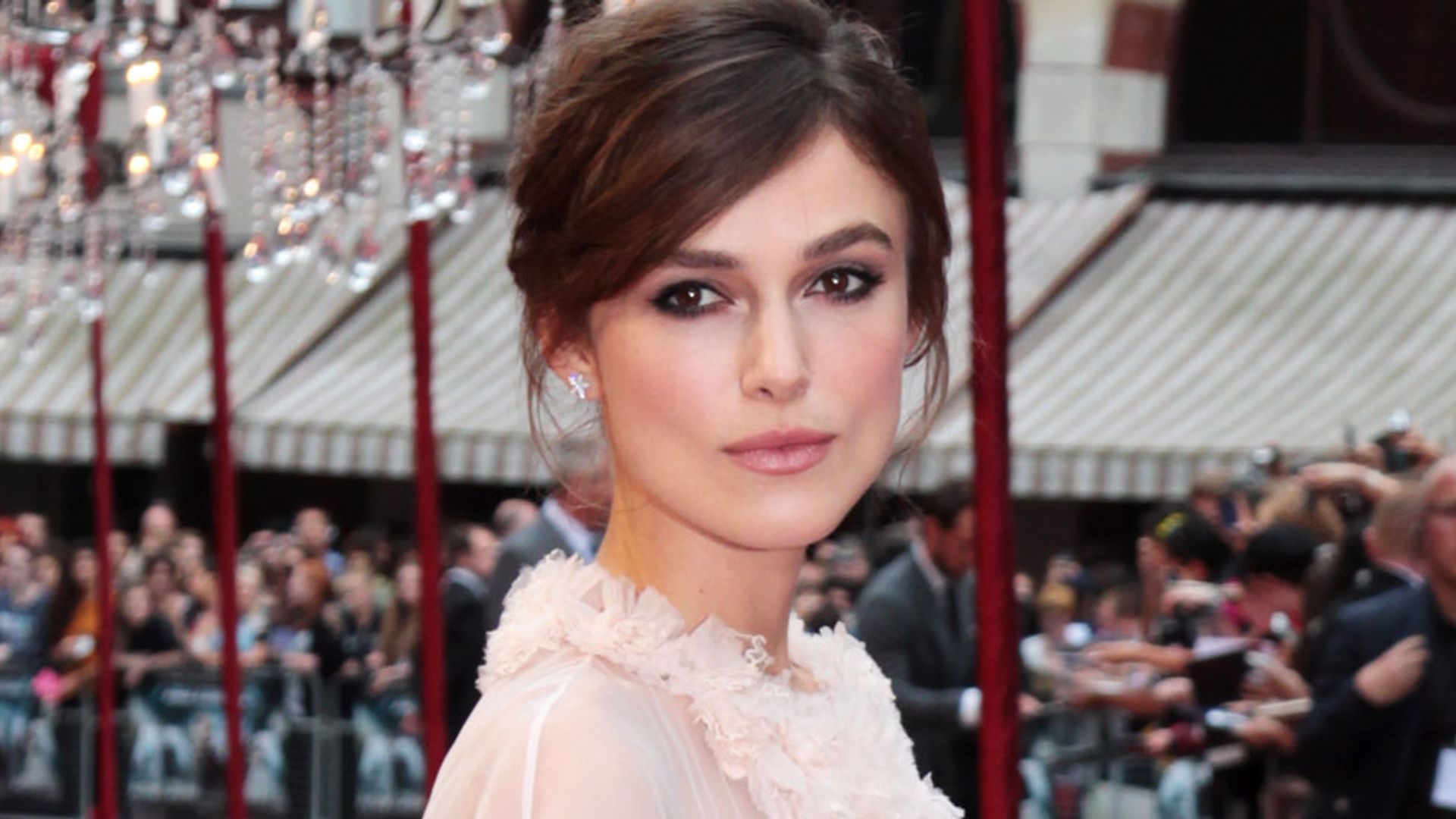 Keira Knightley in a white dress and silver belt on the red carpet