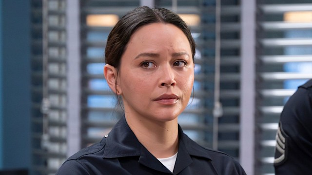 Woman in police uniform with arms crossed