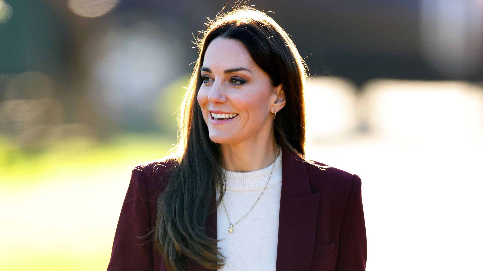 Kate Middleton wearing burgundy trouser suit