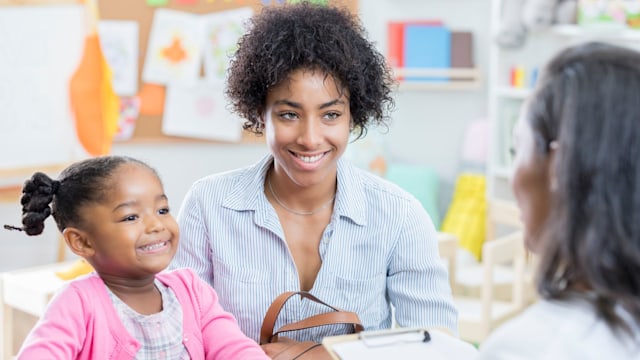 Mum and daughter talk to teacher