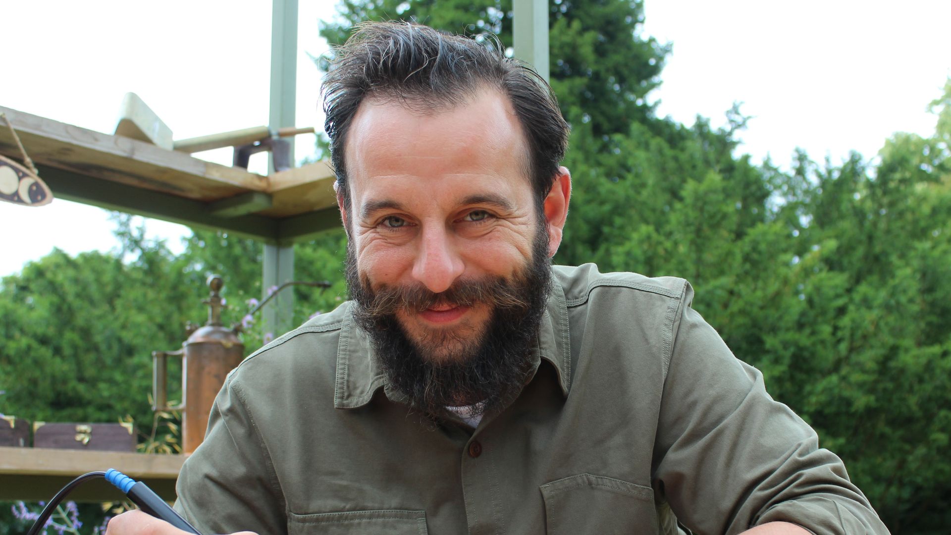 man sitting at workshop table