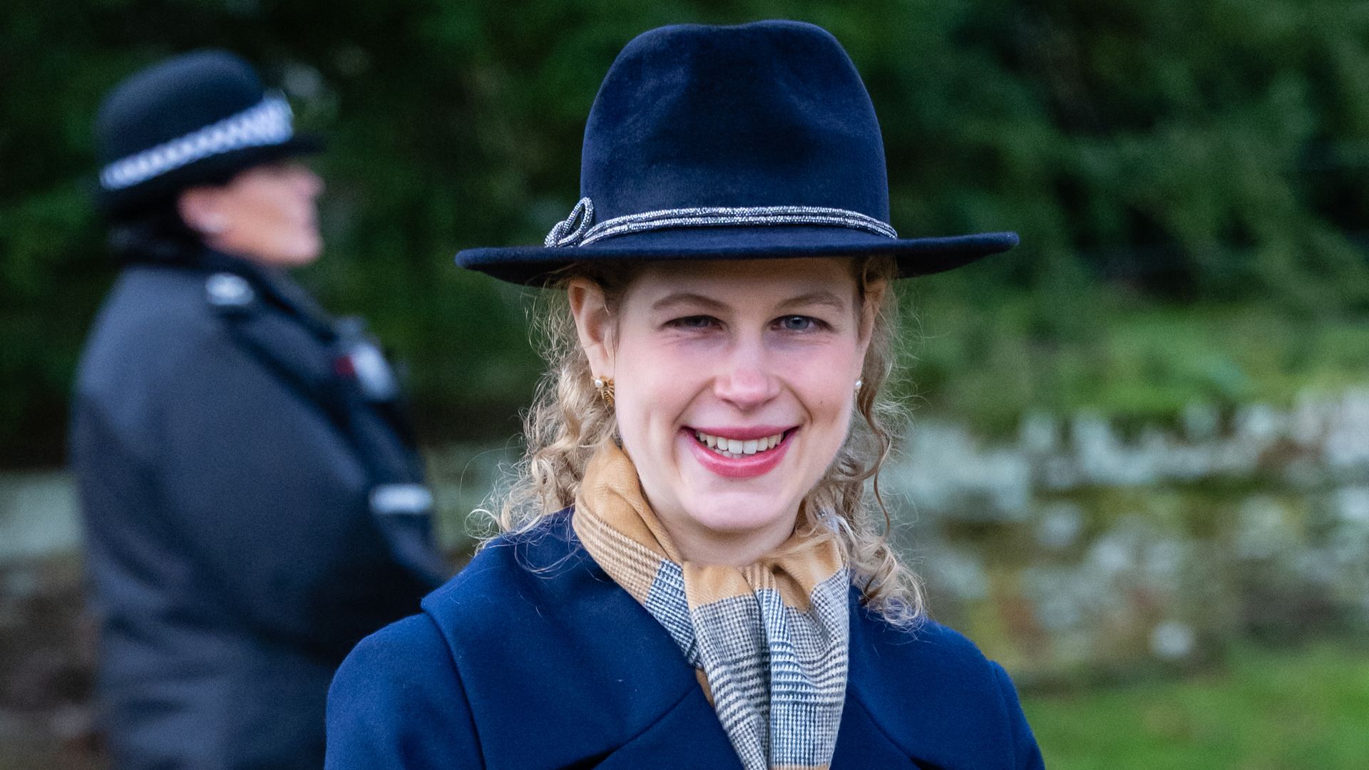 Lady Louise Windsor smiling in hat and coat