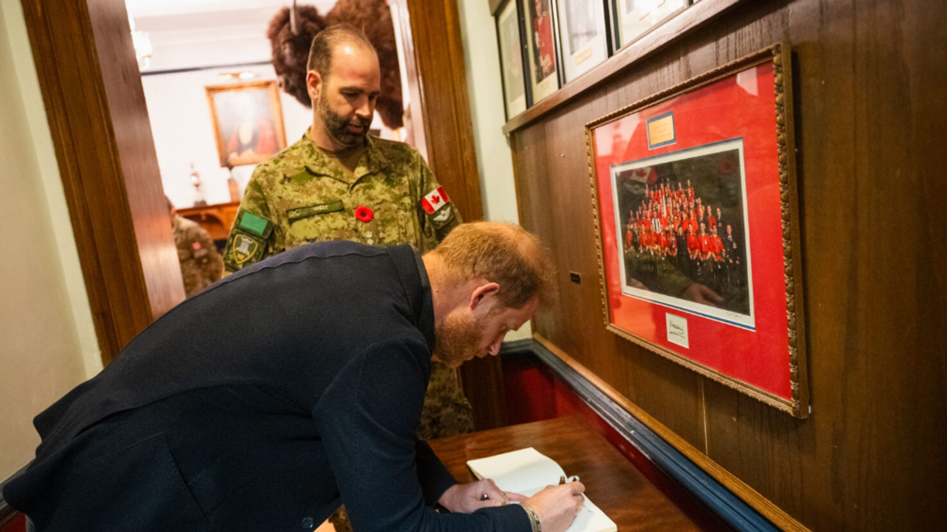Prince Harry signing a book