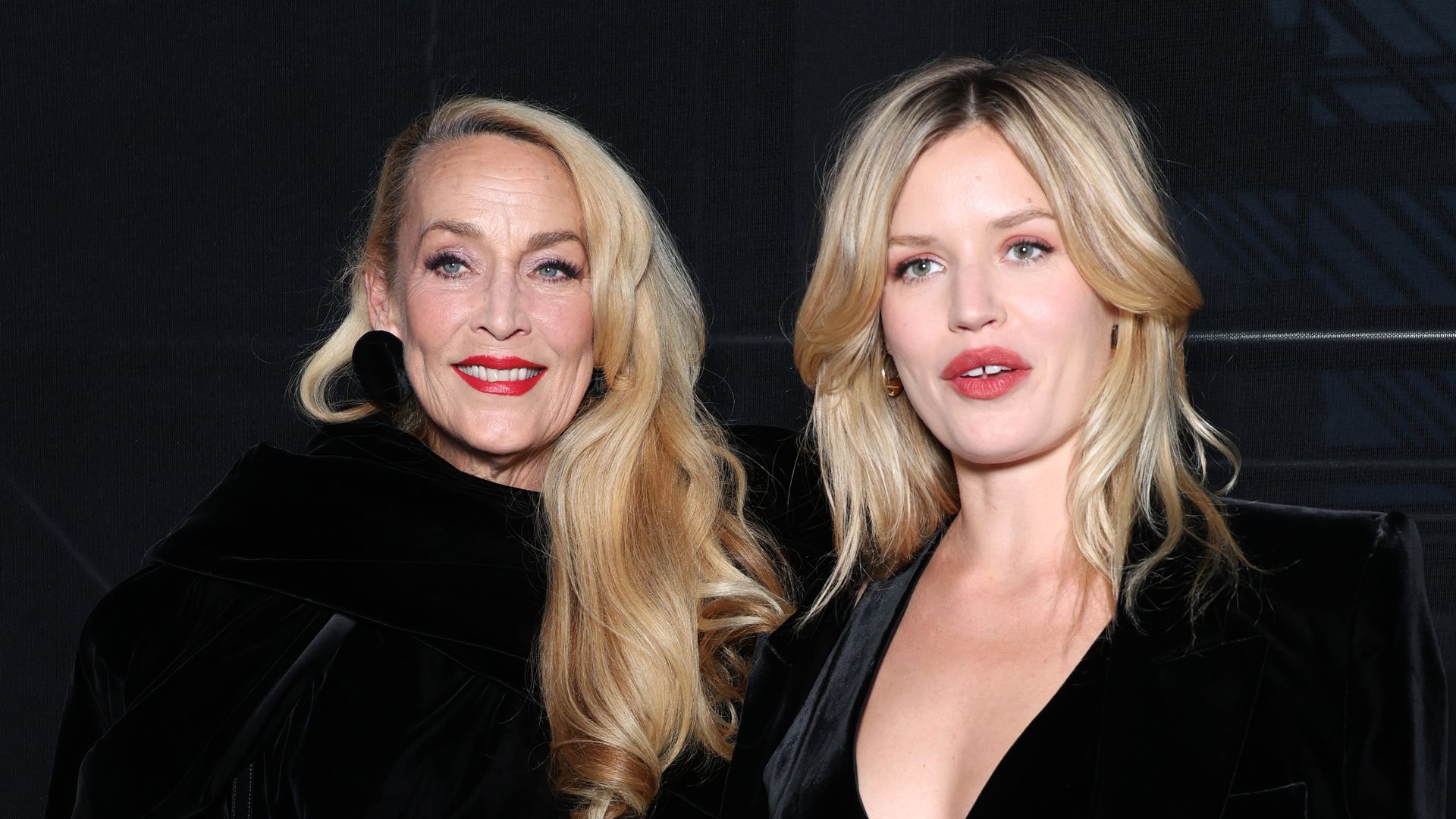 Model Jerry Hall and her daughter Georgia May Jagger smiling in black at Saint Laurent's SS24 show